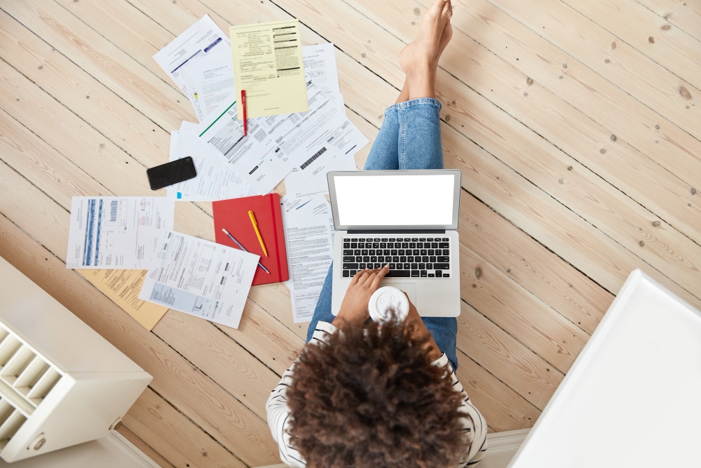 a freelancer sitted on the floor calculating Bulgaria freelance tax